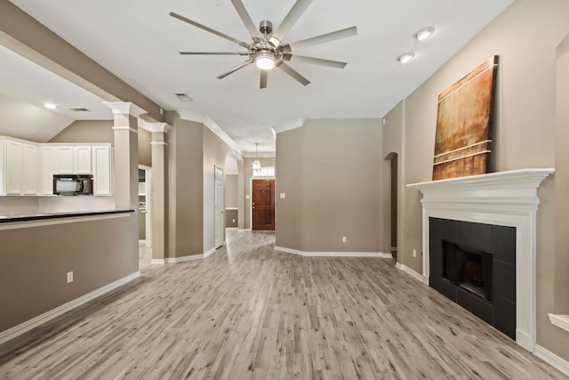 15919 Shadow Pass Trl, Tomball, TX 77377 - unfurnished living room with a ceiling fan, light wood finished floors, a fireplace, recessed lighting, and ornamental molding