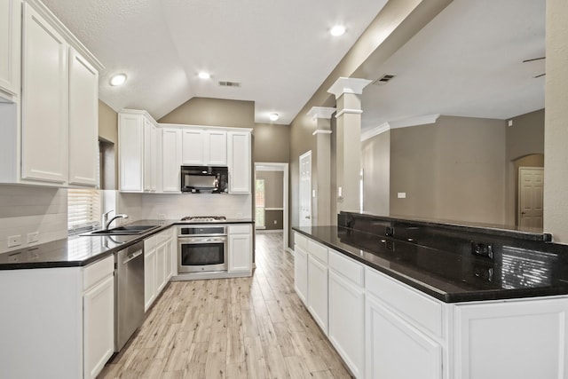 15919 Shadow Pass Trl, Tomball, TX 77377 - kitchen with stainless steel appliances, light wood-style flooring, white cabinetry, backsplash, and dark countertops