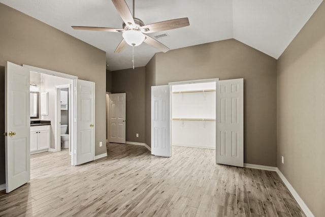 15919 Shadow Pass Trl, Tomball, TX 77377 - unfurnished bedroom featuring light wood finished floors, vaulted ceiling, a ceiling fan, and connected bathroom