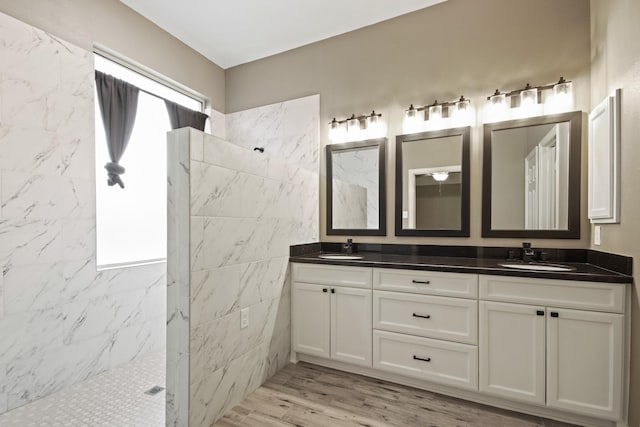 15919 Shadow Pass Trl, Tomball, TX 77377 - full bathroom featuring a marble finish shower, double vanity, and wood finished floors
