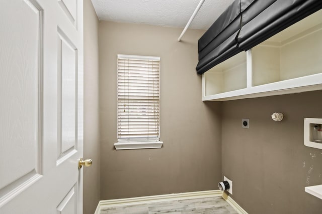 15919 Shadow Pass Trl, Tomball, TX 77377 - washroom with electric dryer hookup, wood finished floors, gas dryer hookup, hookup for a washing machine, and a textured ceiling