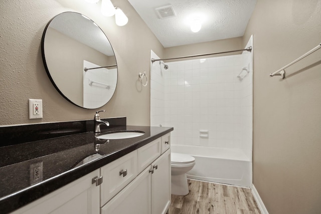 15919 Shadow Pass Trl, Tomball, TX 77377 - bathroom with vanity, wood finished floors, tub / shower combination, and a textured ceiling