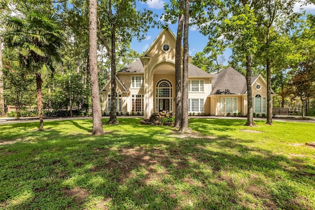 193 Grogans Point Rd, The Woodlands, TX 77380 - view of front facade featuring a front yard and stucco siding