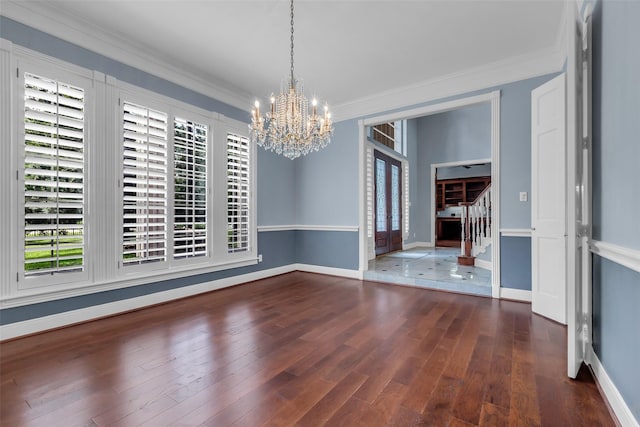 193 Grogans Point Rd, The Woodlands, TX 77380 - unfurnished dining area featuring a chandelier, ornamental molding, wood finished floors, and stairway