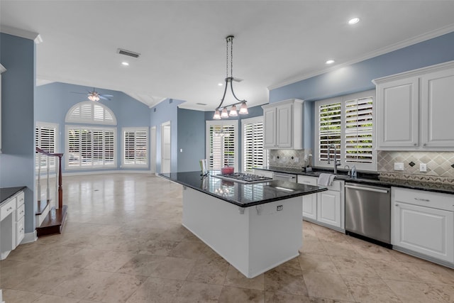 193 Grogans Point Rd, The Woodlands, TX 77380 - kitchen with stainless steel appliances, crown molding, plenty of natural light, a ceiling fan, and backsplash
