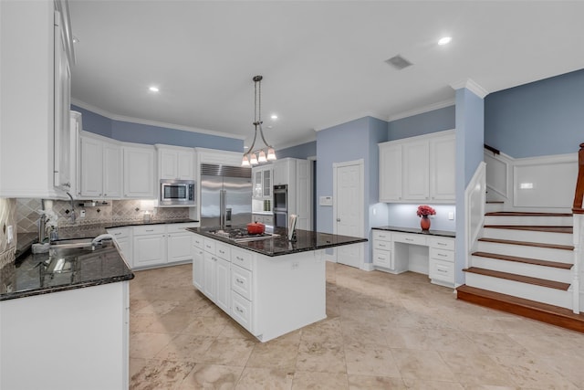 193 Grogans Point Rd, The Woodlands, TX 77380 - kitchen with built in appliances, backsplash, crown molding, white cabinetry, and a kitchen island