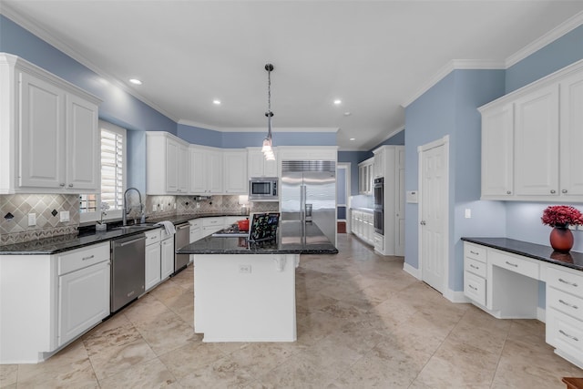 193 Grogans Point Rd, The Woodlands, TX 77380 - kitchen featuring built in appliances, crown molding, a center island, decorative backsplash, and white cabinetry