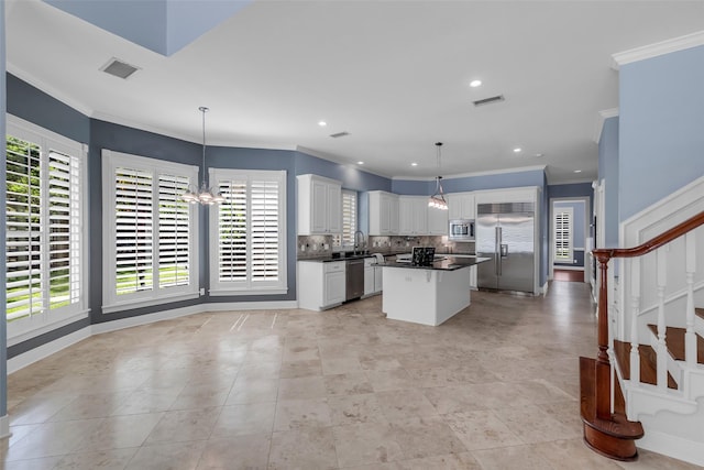 193 Grogans Point Rd, The Woodlands, TX 77380 - kitchen featuring built in appliances, dark countertops, a chandelier, decorative backsplash, and white cabinetry