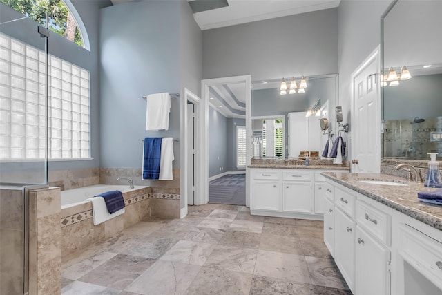193 Grogans Point Rd, The Woodlands, TX 77380 - full bathroom with two vanities, a stall shower, a garden tub, and a high ceiling