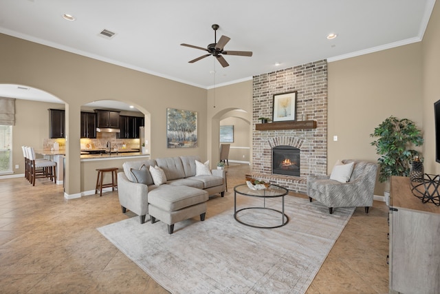 10527 Caddo Lake Dr, Needville, TX 77461 - living room featuring a ceiling fan, arched walkways, light tile patterned floors, recessed lighting, and ornamental molding