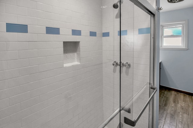 4047 Falkirk Ln, Houston, TX 77025 - bathroom featuring a tile shower and wood finished floors