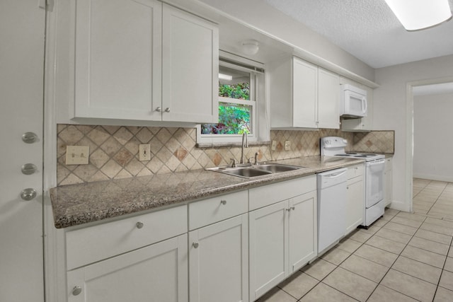 4047 Falkirk Ln, Houston, TX 77025 - kitchen featuring white appliances, white cabinets, decorative backsplash, light tile patterned floors, and a textured ceiling