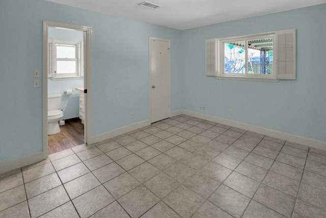 4047 Falkirk Ln, Houston, TX 77025 - unfurnished bedroom with baseboards and light tile patterned flooring