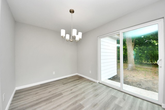5634 Beldart St, Houston, TX 77033 - empty room featuring wood finished floors and a chandelier