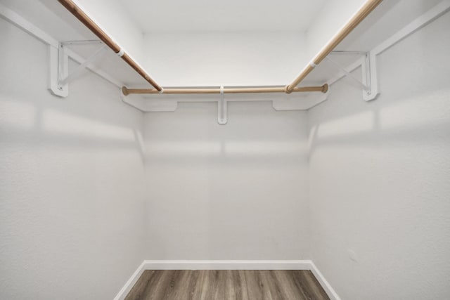 5634 Beldart St, Houston, TX 77033 - spacious closet featuring dark wood-style floors