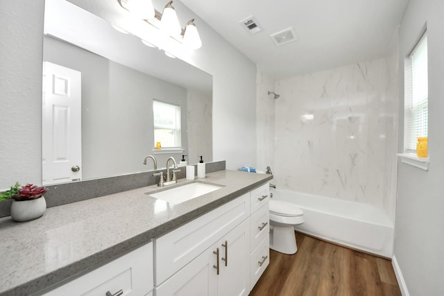5634 Beldart St, Houston, TX 77033 - full bath featuring vanity, wood finished floors, and bathing tub / shower combination