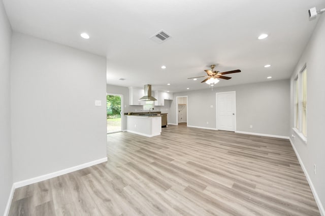 5634 Beldart St, Houston, TX 77033 - unfurnished living room with a ceiling fan, recessed lighting, and light wood-style floors