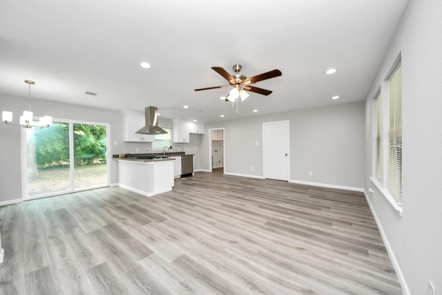 5634 Beldart St, Houston, TX 77033 - unfurnished living room featuring a ceiling fan, light wood-type flooring, recessed lighting, and a chandelier