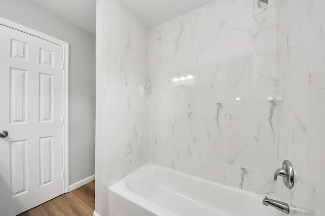 5634 Beldart St, Houston, TX 77033 - bathroom featuring shower / tub combination and wood finished floors