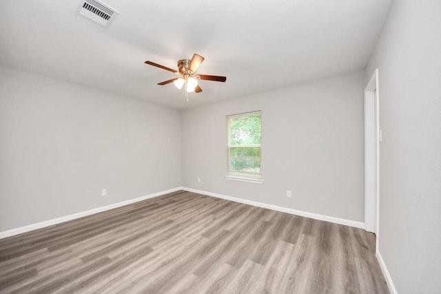 5634 Beldart St, Houston, TX 77033 - empty room with a ceiling fan and wood finished floors