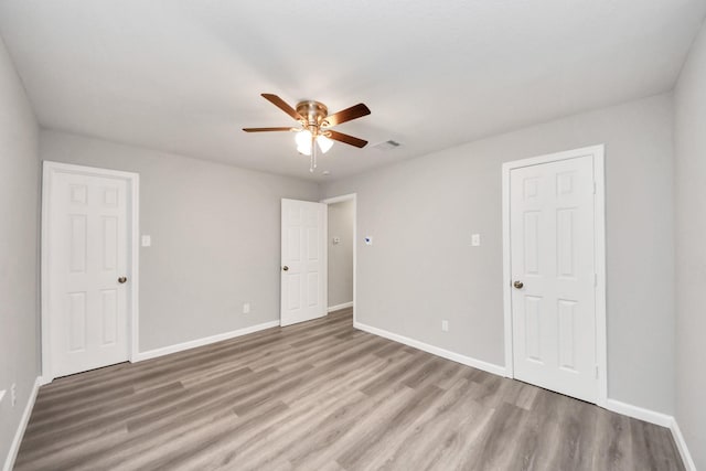 5634 Beldart St, Houston, TX 77033 - unfurnished bedroom with wood finished floors and ceiling fan