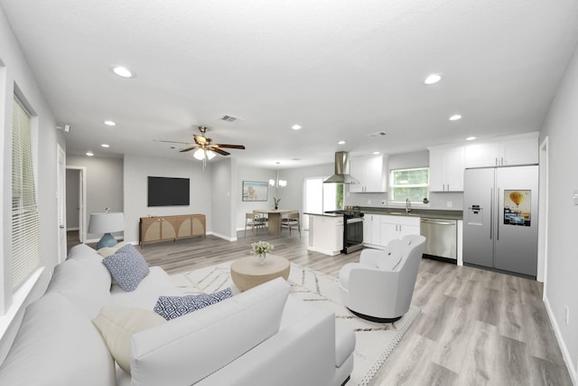 5634 Beldart St, Houston, TX 77033 - living room featuring light wood-style floors, recessed lighting, and ceiling fan