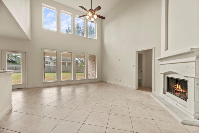 4403 Lodge Vine Ct, Sugar Land, TX 77479 - unfurnished living room featuring high vaulted ceiling, a ceiling fan, a fireplace, and light tile patterned flooring