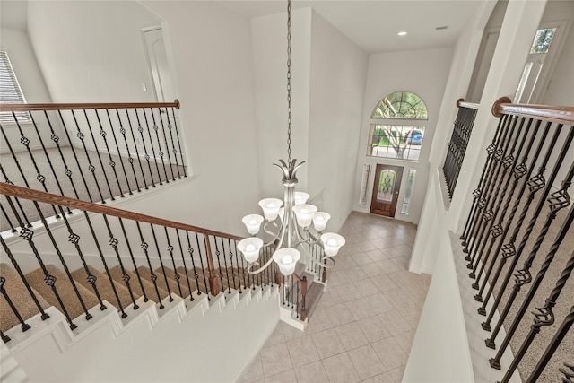 4403 Lodge Vine Ct, Sugar Land, TX 77479 - foyer entrance with light tile patterned floors, a chandelier, stairway, and recessed lighting