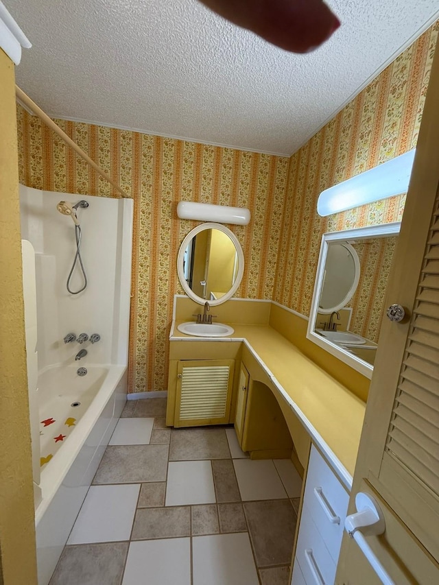 427 22nd Ave N, Texas City, TX 77590 - bathroom with wallpapered walls, a textured ceiling, vanity, shower / bathtub combination, and tile patterned floors