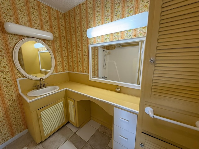 427 22nd Ave N, Texas City, TX 77590 - bathroom with tile patterned flooring, wallpapered walls, and vanity