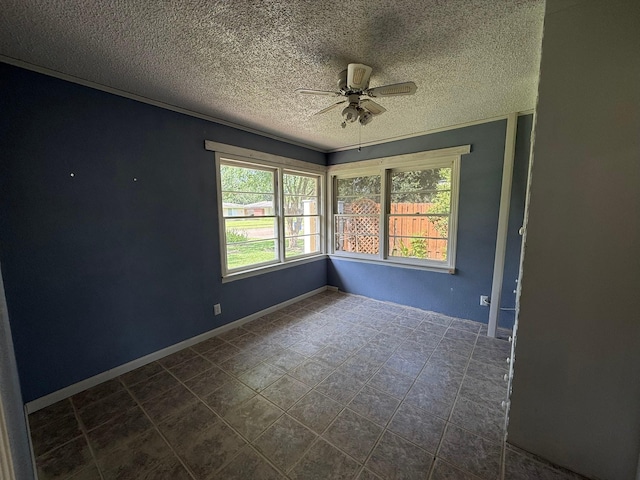 427 22nd Ave N, Texas City, TX 77590 - unfurnished room with a textured ceiling, ceiling fan, and dark tile patterned flooring