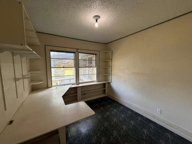 427 22nd Ave N, Texas City, TX 77590 - unfurnished office featuring a textured ceiling and baseboards