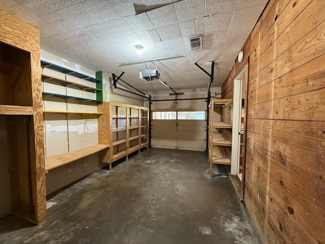 427 22nd Ave N, Texas City, TX 77590 - garage featuring a garage door opener and wood walls