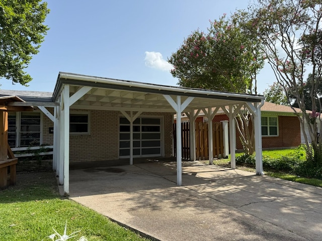427 22nd Ave N, Texas City, TX 77590 - back of house featuring brick siding, a carport, and concrete driveway