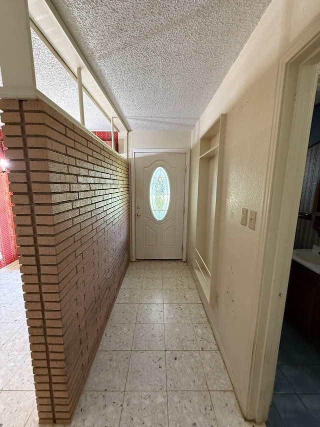 427 22nd Ave N, Texas City, TX 77590 - entryway featuring brick wall and a textured ceiling