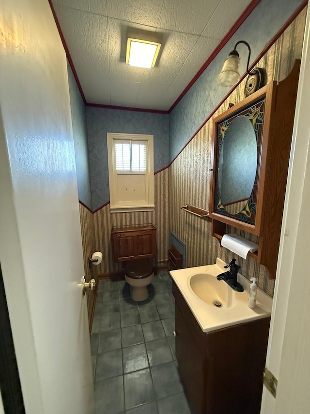 427 22nd Ave N, Texas City, TX 77590 - bathroom featuring wallpapered walls, vanity, crown molding, tile patterned floors, and wainscoting
