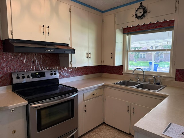 427 22nd Ave N, Texas City, TX 77590 - kitchen with electric stove, ventilation hood, light countertops, and white cabinetry