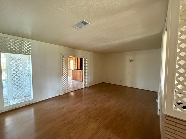 427 22nd Ave N, Texas City, TX 77590 - spare room with wood finished floors, a textured ceiling, and healthy amount of natural light