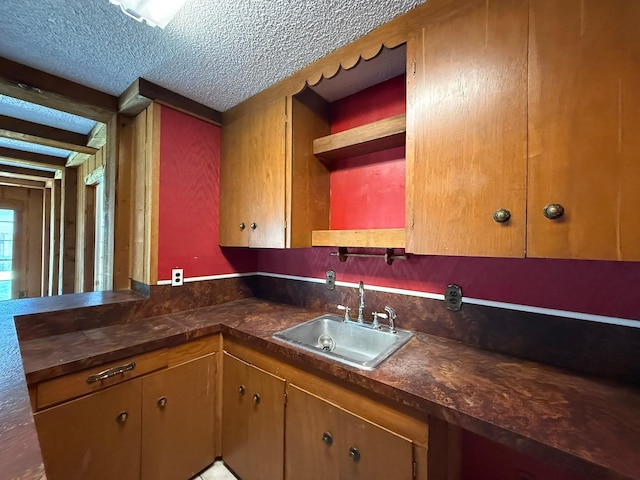 427 22nd Ave N, Texas City, TX 77590 - kitchen featuring open shelves, a textured ceiling, dark countertops, and a peninsula