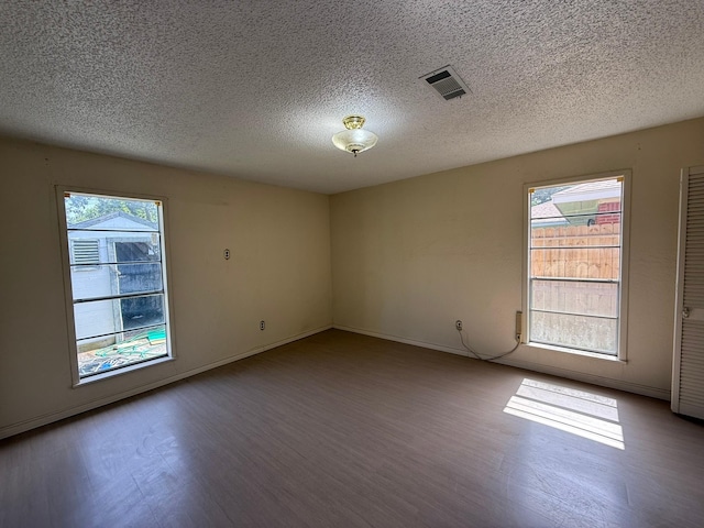 427 22nd Ave N, Texas City, TX 77590 - empty room featuring a textured ceiling and wood finished floors