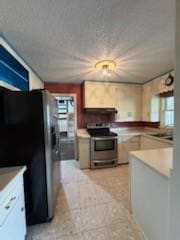 427 22nd Ave N, Texas City, TX 77590 - kitchen with stainless steel electric range oven, freestanding refrigerator, light countertops, and range hood