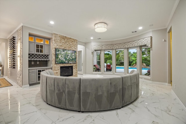 17310 Venado Dr, Cypress, TX 77433 - living area featuring light marble finish floors, recessed lighting, a stone fireplace, crown molding, and bar