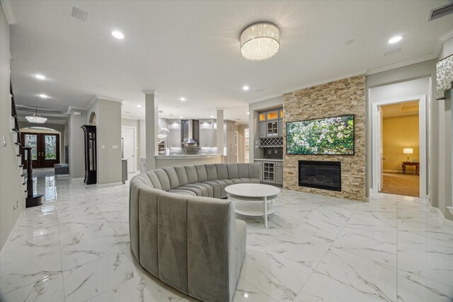 17310 Venado Dr, Cypress, TX 77433 - living area with crown molding, a stone fireplace, recessed lighting, and light marble finish floors