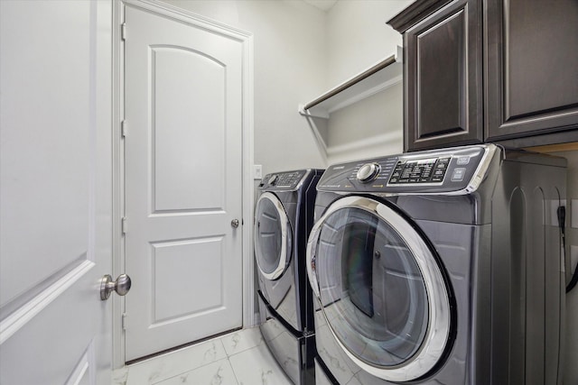 17310 Venado Dr, Cypress, TX 77433 - laundry area with separate washer and dryer, light marble finish flooring, and cabinet space