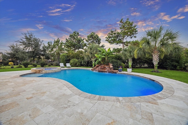 17310 Venado Dr, Cypress, TX 77433 - pool at dusk featuring a patio, a pool with connected hot tub, and a yard