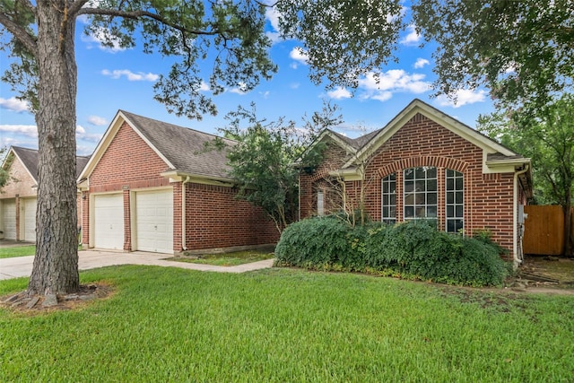 30927 N Head Dr, Spring, TX 77386 - view of front of home with brick siding, a detached garage, and a shingled roof