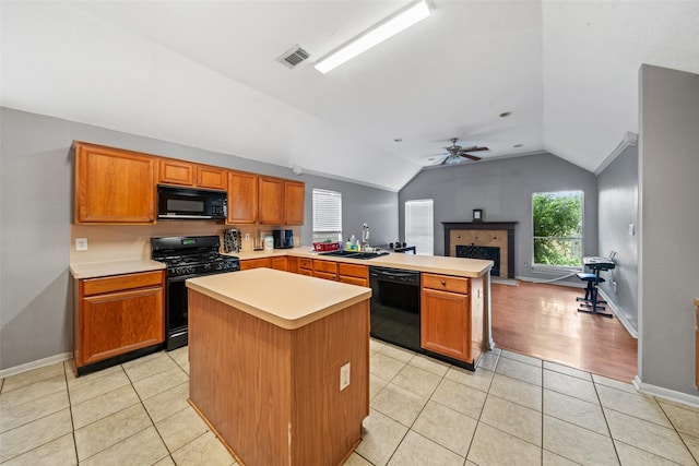30927 N Head Dr, Spring, TX 77386 - kitchen with black appliances, a peninsula, lofted ceiling, light countertops, and a ceiling fan