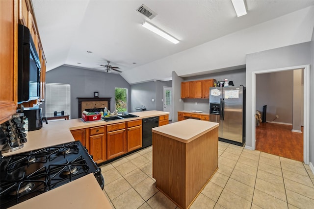 30927 N Head Dr, Spring, TX 77386 - kitchen featuring black appliances, vaulted ceiling, light countertops, a peninsula, and brown cabinetry