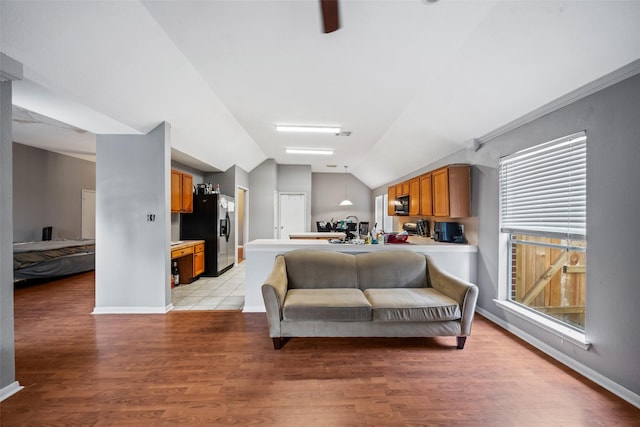 30927 N Head Dr, Spring, TX 77386 - living area featuring vaulted ceiling, light wood-style floors, healthy amount of natural light, and a ceiling fan