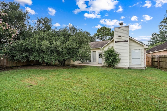 30927 N Head Dr, Spring, TX 77386 - back of house featuring a fenced backyard, a chimney, and a patio area
